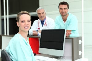 Medical assistants at the front desk of a medical clinic.