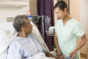 Certified Nursing Assistant taking patient vitals
