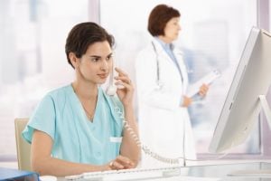 Medical assistant on the phone in a doctor's office