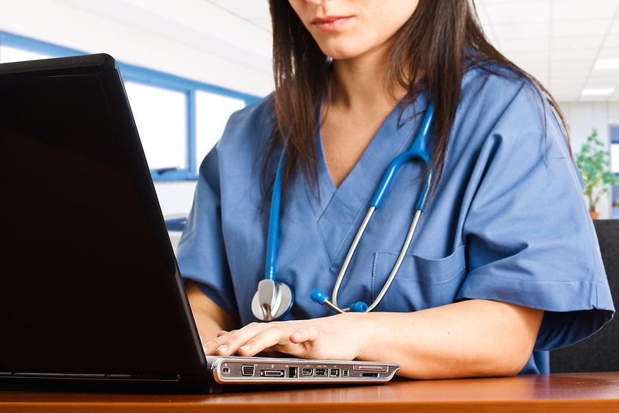 LPN to RN student studying on laptop